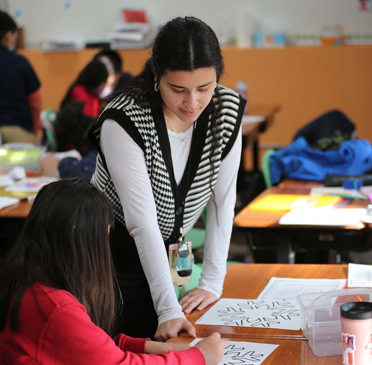 Horizon Science Academy Belmont Teacher and student interacting at a classroom desk